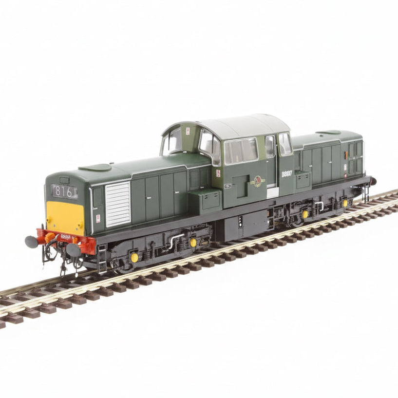 Model train on a railway track with a green and yellow color scheme.