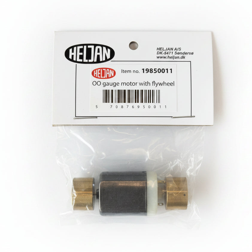 A small Heljan 00 gauge motor with flywheel, sealed in a clear plastic bag with its original white paper packaging label attached, on a white background.